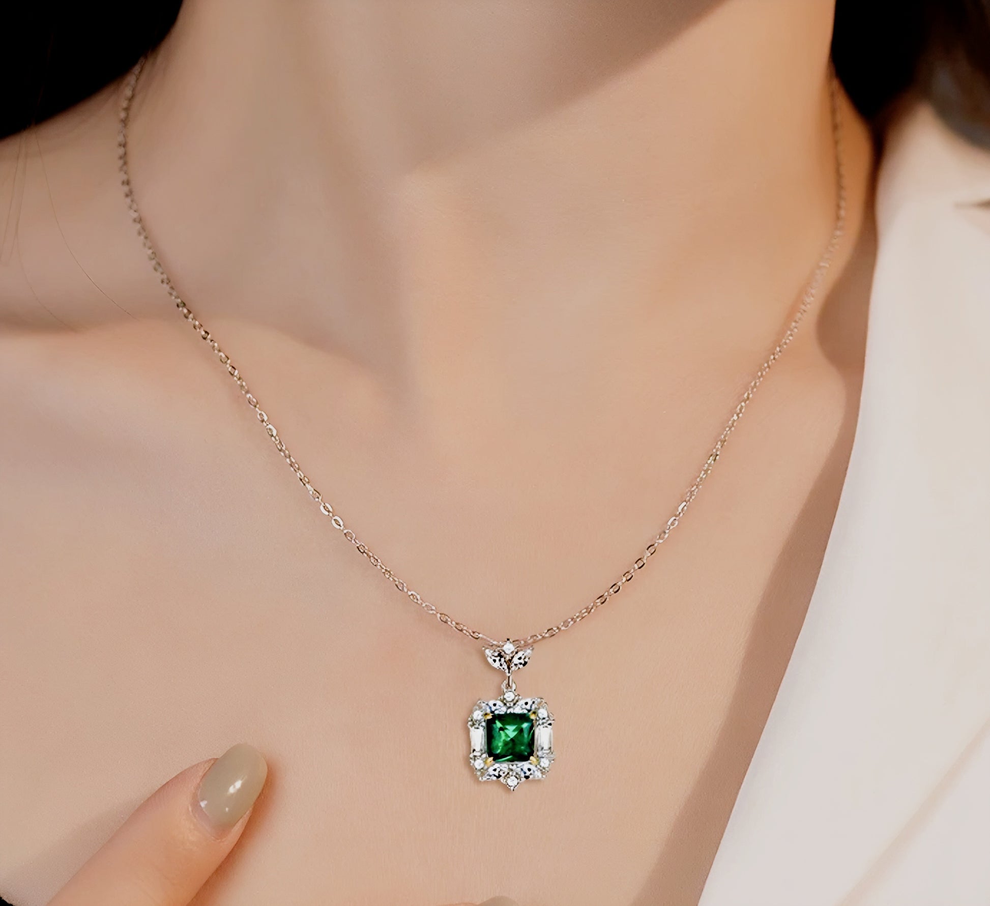 Esmeralda simulated diamond necklace in green color, crafted in sterling silver plated with 18k white gold with rhodium, necklace on woman neck, details of necklace